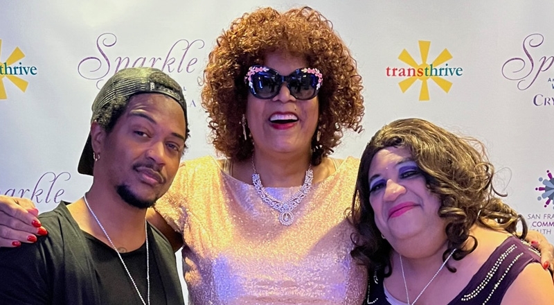 Ms. Billie Cooper posing with two others at a transthrive event